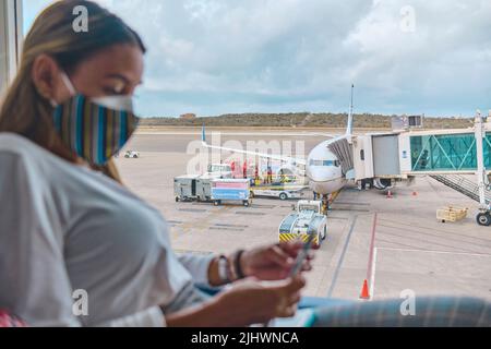 CARACAS, VENEZUELA - 2022: Young woman waiting to board the plane in the lounge the Simon Bolivar Airport, Maiquetia - Venezuela. Stock Photo