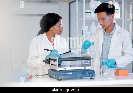 Theyre the brightest minds of their generation. two coworkers working together in a lab. Stock Photo