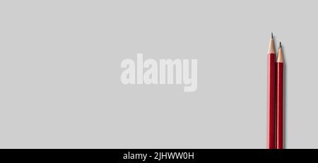 two sharpened pencils close up isolated on gray background. tool for drawing, drafting and drawing up plan of action Stock Photo