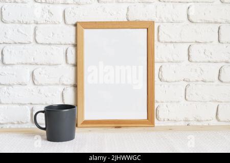 Photo frames on floor over white brick wall Stock Photo