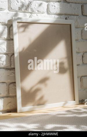 Photo frames on floor over white brick wall Stock Photo