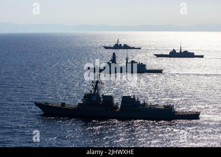 July 6, 2022 - Adriatic Sea - From front, the Arleigh Burke-class guided-missile destroyer USS Bainbridge (DDG 96), the Italian Navy Carlo Bergamini-class frigate ITS Alpino (F 594), the French Navy Aquitaine-class frigate FS Languedoc (D 653), and the Arleigh Burke-class guided-missile destroyer USS Cole (DDG 67), participate in a maneuvering exercise in the Adriatic Sea, July 6, 2022. Bainbridge and Cole are on a scheduled deployment in the U.S. Naval Forces Europe area of operations, employed by U.S. Sixth Fleet to defend U.S., allied and partner interests. (photo by Elexia Morelos) (Credit Stock Photo