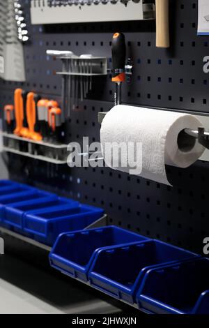Workshop interior with metal pegboard panels. Workshop with tools hanging on a wall. Selective focus. Stock Photo