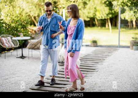 Stylish couple spend summer time at the backyard Stock Photo