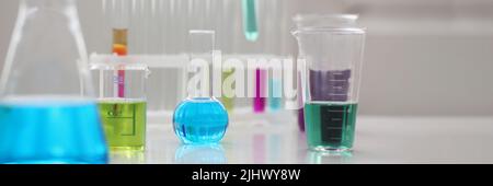 Working mess, lab tubes stand on table in laboratory of liquid testing Stock Photo