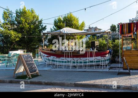Ksamil, Albania - September 9, 2021: Street view of Ksamil at day with the Boat-Bar in Ksamil, Albania. Stock Photo