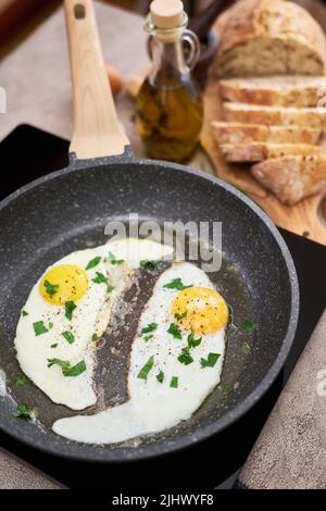 Close up view of the fried egg on a frying pan Stock Photo