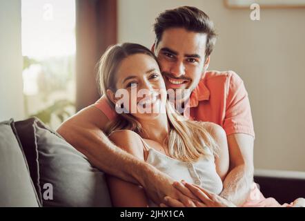 Growing together. a young couple spending time together at home. Stock Photo