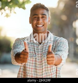 Ive picked a lot today. a young man giving a thumbs up on a farm. Stock Photo