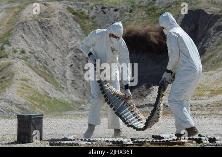 Utah, USA. 23rd June, 2022. U.S. Air Force National Guard Master Sgt. Derin Creek and Staff Sgt. Cody Bialcak, Explosive Ordnance Disposal Techinicians, safely remove over 500 depleted uranium rounds on June 23, 2022 at Tooele Army Depot, UT. The Utah Air National Guard Explosive Ordnance Disposal Squadron was tasked to execute an Emergency detonation of several depleted uranium rounds that had been compromised. Credit: U.S. National Guard/ZUMA Press Wire Service/ZUMAPRESS.com/Alamy Live News Stock Photo