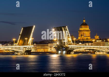 White nights in St. Petersburg. St. Isaac's Cathedral and the divorced Annunciation Bridge. Beautiful night cityscape Stock Photo