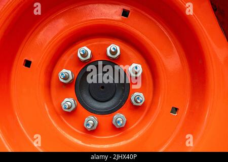 Detail of bolts on the rim of a tractor wheel Stock Photo