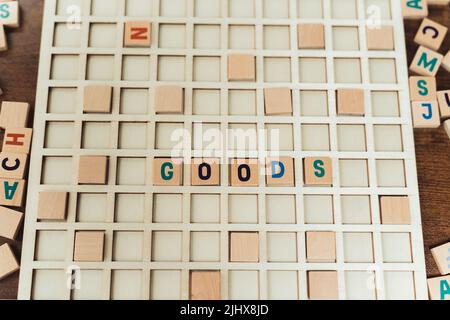 goods word made of wooden letter cubes on vocabulary game grid - stock market metaphore. High quality photo Stock Photo