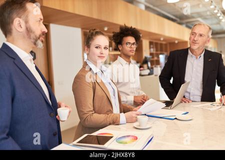 Group of business people as a creative designer team at the conference table in a meeting Stock Photo