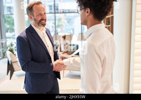 Two business people handshake as concept for partnership and cooperation Stock Photo