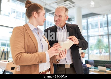 Business man and young business woman as IT security officers with tablet PC Stock Photo