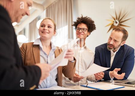 Young start-up team presents a project idea at the strategy meeting in the office Stock Photo
