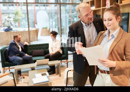 Senior business man as manager or consultant and woman as startup founder in the office Stock Photo