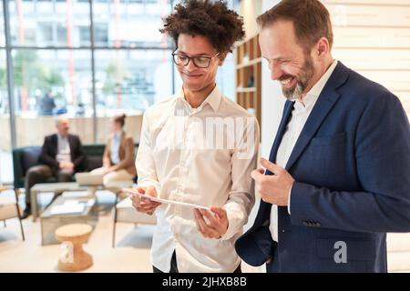Business start-up founders and consultants or colleagues are happy about the business plan Stock Photo