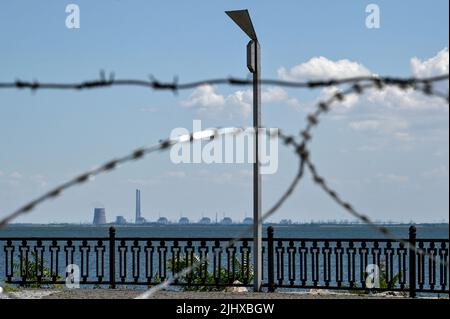 NIKOPOL, UKRAINE - JULY 20, 2022 - The Zaporizhzhia Nuclear Power Plant in Enerhodar, Zaporizhzhia Region, is seen through barbed wire on the embankme Stock Photo