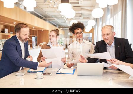 Successful business team in the office collaborating on the laptop computer Stock Photo