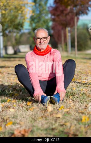 Senior Man Exercising In Park Stock Photo