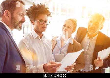 Multicultural business team collaborating in the office Stock Photo