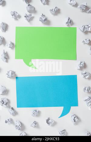Paper Wraps Placed Around Two Speech Bubbles With Important Informations. Wrinkled Notes Arranged All Over Different Dialogue Ballons With Crutial Stock Photo