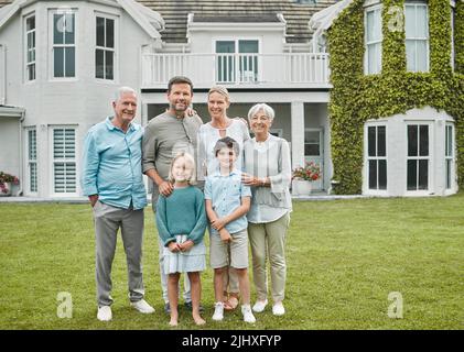 Our house is filled with love. a multi-generational family standing together outside. Stock Photo