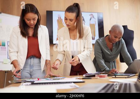 Designers with a dream. a group of female designers working in an office. Stock Photo