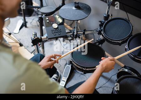 Cropped view of african american customer playing electronic drums in music shop Stock Photo