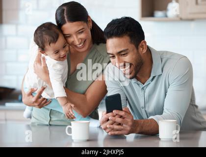 We just got exciting news. a young family spending time together at home. Stock Photo