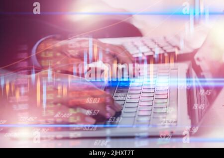 Businessman hand using laptop computer typing keyboard  analysis and economic growth big data stock market with financial graphs. Concepts of digital Stock Photo