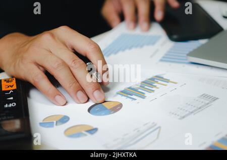 businessman data document graph chart report marketing research development working at office with laptop. Stock Photo