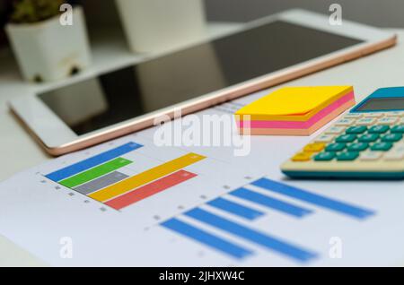 Business document chart and graph analysis finance information investment report on desk at office. Stock Photo