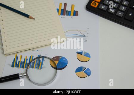 Document finance report paper datum graph diagram investment and pen magnifying glass.Business accounting economy information concept. Stock Photo