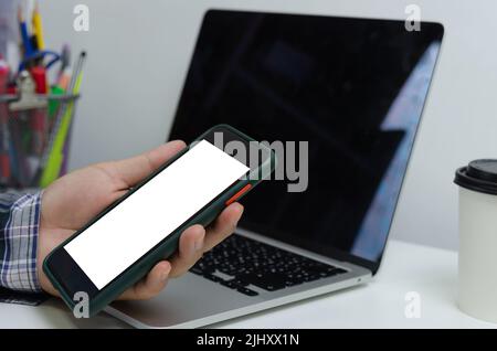 Hand man holding mobile smartphone mock up blank white screen technology online internet digital advertising business concept. Stock Photo