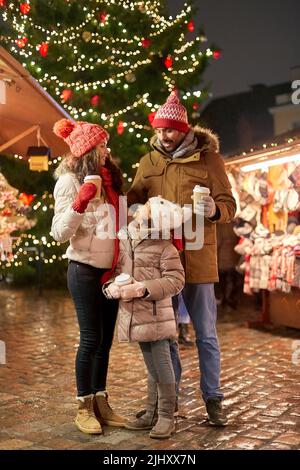 family with takeaway drinks at christmas market Stock Photo