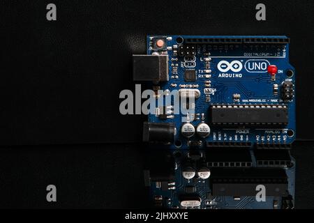 Arduino UNO board on black background Stock Photo