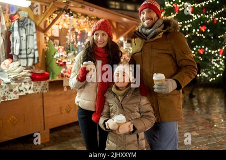 family with takeaway drinks at christmas market Stock Photo