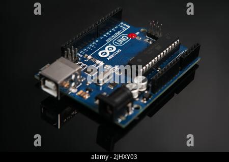 Arduino UNO board on black glance background Stock Photo