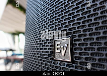 Close-up of the EV Electro Voice logo on large speakers set up at a outdoor event Stock Photo