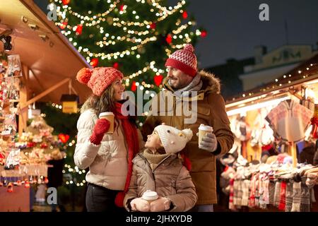 family with takeaway drinks at christmas market Stock Photo