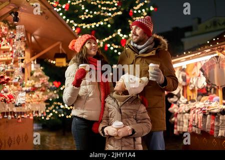 family with takeaway drinks at christmas market Stock Photo