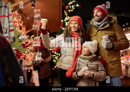 family with takeaway drinks at christmas market Stock Photo