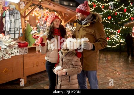 family with takeaway drinks at christmas market Stock Photo