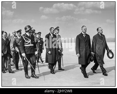 1938 Munich Agreement. Arrival of Neville Chamberlain. Landing of the British Prime Minister Neville Chamberlain at the Munich airfield Oberwiesenfeld on September 29th. 1938. Nevile Henderson (ambassador of the United Kingdom to Nazi Germany), Joachim von Ribbentrop ( Minister of Foreign Affairs of Nazi Germany from 1938 to 1945 Peace in our Time Stock Photo