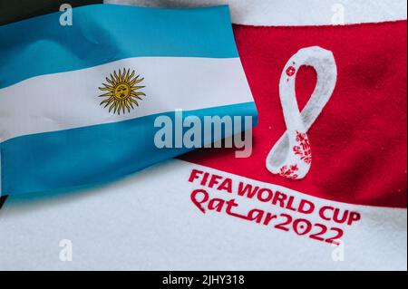 QATAR, DOHA, 18 JULY, 2022: Argentina National flag and logo of FIFA World Cup in Qatar 2022 on red carpet. Soccer sport background, edit space. Qatar Stock Photo