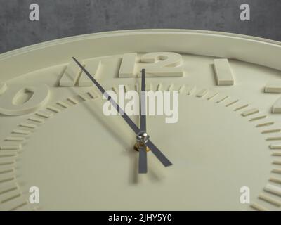 Wall clock on a gray background. Clock close-up. Watch face with large numbers. Stock Photo
