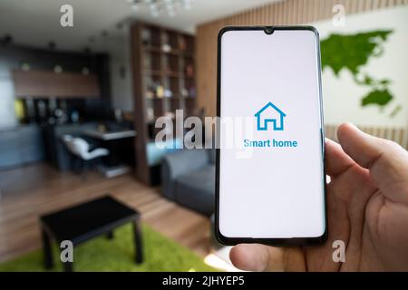 smart home app on smartphone. remote control of electronic devices in apartment. concept of controlling smart electronics in the house. Internet of Th Stock Photo